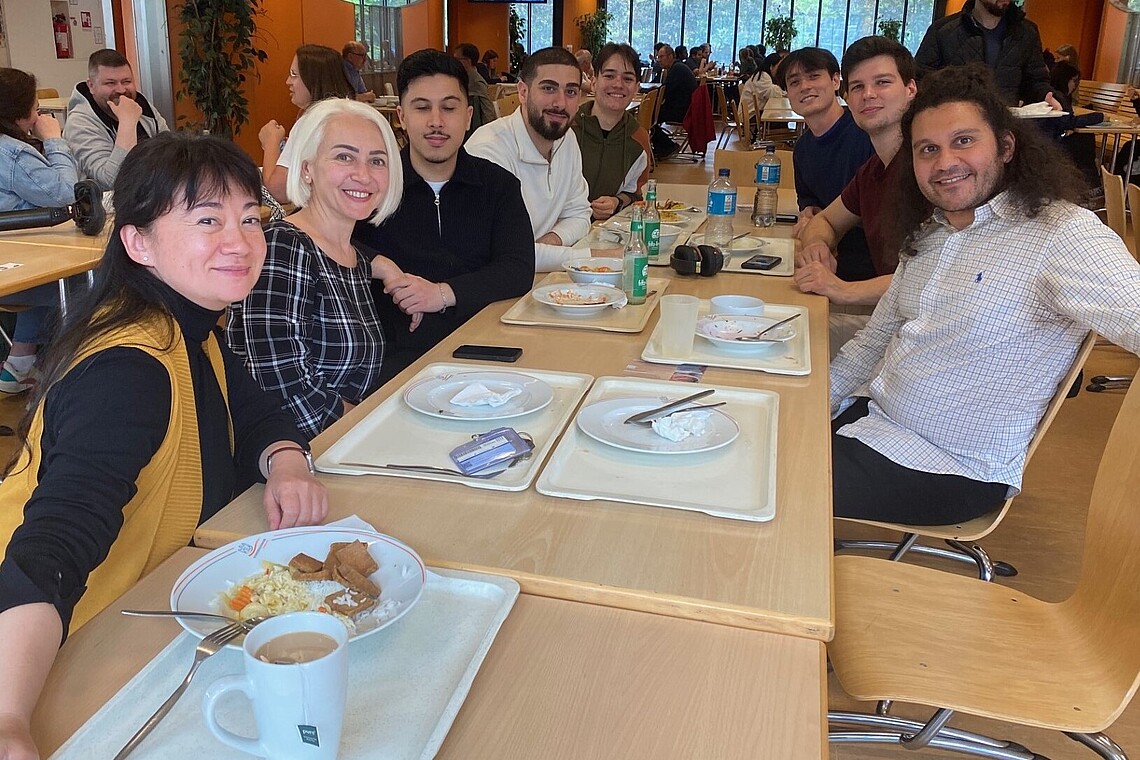 Group of professors and students at a cafeteria table
