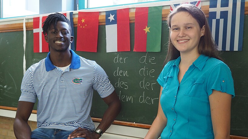 Male and female student smiling into the camera