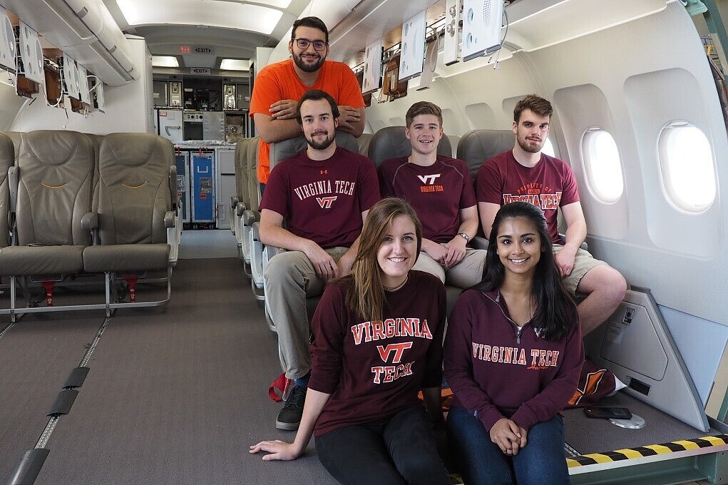 Male and female students sitting in an aircraft cabin