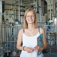 Female student standing in a chemistry lab