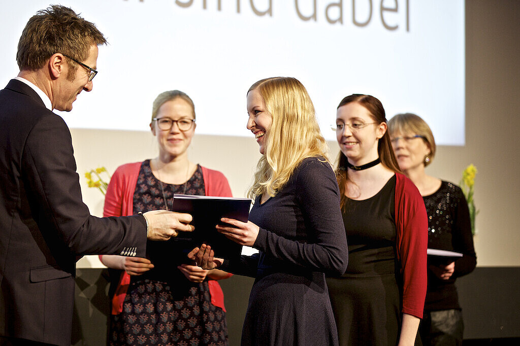 Präsident der Hochschule, Prof. Dr. Micha Teuscher überreicht die Stipendienurkunden