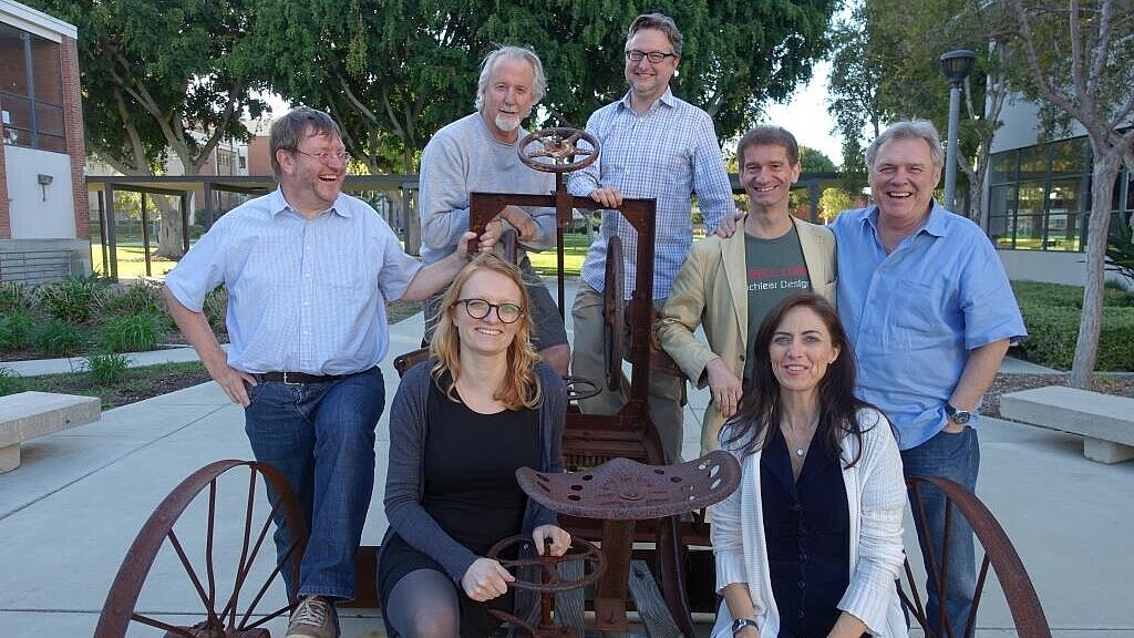 Group of professors laughing into the camera