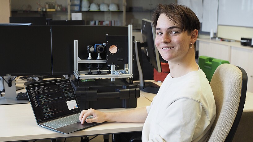 Male student with lap top in a research lab