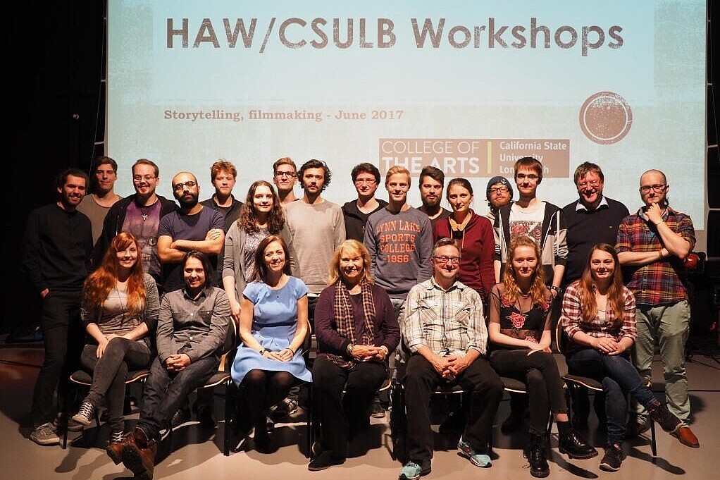 Group of people sitting in front of a video screen