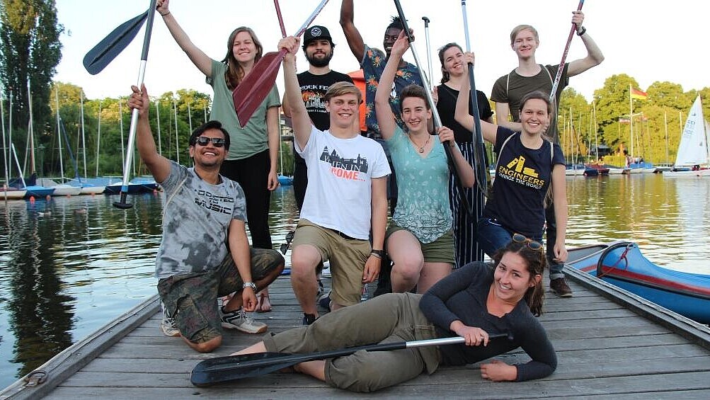 Group of students with canoe paddles